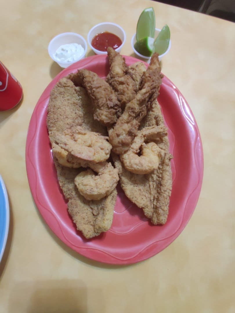 Crispy shrimp beside coleslaw and sides.