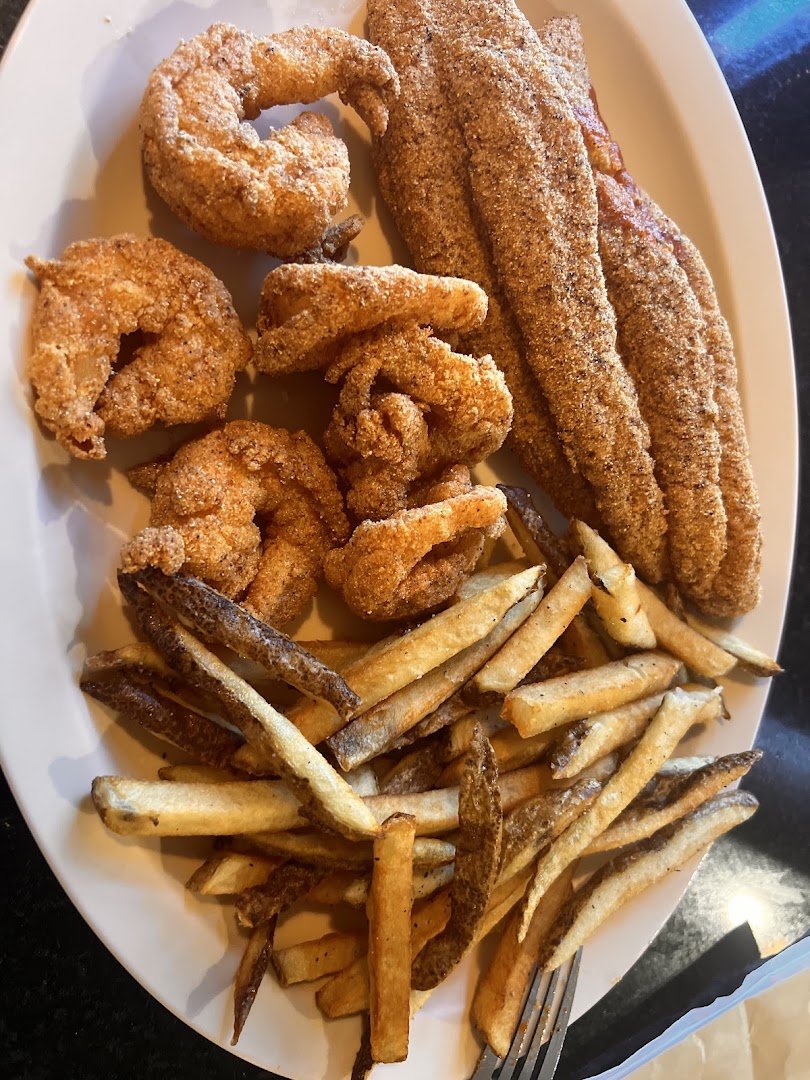 Crispy shrimp beside coleslaw and sides.